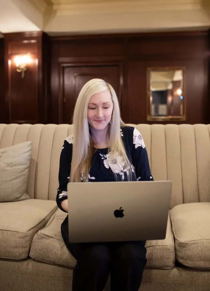 Kari working on laptop sitting on couch